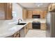 Kitchen with wood cabinets, white tile counters, and stainless steel appliances at 10160 E Conieson Rd, Scottsdale, AZ 85260