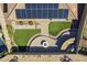 An aerial view showcases a home's backyard with synthetic grass, a fire pit, a bar, and desert landscaping at 10251 W Gambit Trl, Peoria, AZ 85383