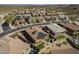 An aerial view shows homes with solar panels, desert landscaping, pools, and outdoor living spaces at 10251 W Gambit Trl, Peoria, AZ 85383