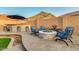 Outdoor kitchen and fire pit offers an ideal space for entertaining, with lush landscaping at 10251 W Gambit Trl, Peoria, AZ 85383