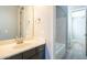 This bathroom features vanity with sleek lines, complementing the nearby shower with neutral color palette at 10251 W Gambit Trl, Peoria, AZ 85383