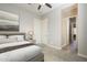 This bedroom displays an ensuite bathroom entrance, closet and a neutral color palette, creating a harmonious retreat at 10251 W Gambit Trl, Peoria, AZ 85383