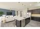 Well-designed kitchen with a central island, modern appliances, and seamless integration with the living area at 10251 W Gambit Trl, Peoria, AZ 85383