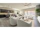 Open-concept living space with a kitchen island, dining area, and comfortable seating arrangements at 10251 W Gambit Trl, Peoria, AZ 85383