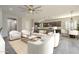 Spacious living area featuring stylish decor, a kitchen view, and plenty of natural light at 10251 W Gambit Trl, Peoria, AZ 85383