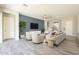 Inviting living room with modern decor, a ceiling fan, and large windows providing ample natural light at 10251 W Gambit Trl, Peoria, AZ 85383