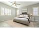 Serene bedroom with neutral walls, plantation shutters, and elegant furnishings for a peaceful retreat at 10251 W Gambit Trl, Peoria, AZ 85383