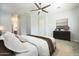 This main bedroom features a ceiling fan, a large dresser, and a neutral color palette, creating a serene retreat at 10251 W Gambit Trl, Peoria, AZ 85383