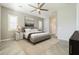 Relaxing bedroom with an area rug, ceiling fan, and access to an ensuite bathroom for added convenience at 10251 W Gambit Trl, Peoria, AZ 85383
