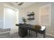Bright and airy office space with a modern desk, shelving, and a comfortable chair at 10251 W Gambit Trl, Peoria, AZ 85383