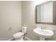 This powder room offers a pedestal sink and modern toilet at 10251 W Gambit Trl, Peoria, AZ 85383