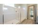 This bathroom shows a seamless glass shower door design, bright white interior, and a full-length mirror at 10251 W Gambit Trl, Peoria, AZ 85383