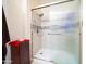 Bathroom showcasing a glass-enclosed shower with modern fixtures at 10326 W Kingswood Cir, Sun City, AZ 85351
