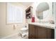 Bathroom featuring a modern vanity with granite countertop and a toilet at 10326 W Kingswood Cir, Sun City, AZ 85351