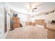 Bedroom with a ceiling fan, window shutters, and carpeted flooring at 10326 W Kingswood Cir, Sun City, AZ 85351