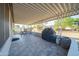 View of a covered patio with tiled flooring and outdoor seating, perfect for entertaining or relaxation at 10326 W Kingswood Cir, Sun City, AZ 85351