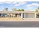 Charming home featuring a low-maintenance front yard, covered porch, and attached garage for convenient parking at 10326 W Kingswood Cir, Sun City, AZ 85351