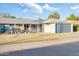 Charming home featuring a low-maintenance front yard, covered porch, and attached garage for convenient parking at 10326 W Kingswood Cir, Sun City, AZ 85351