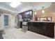 Modern kitchen with stainless steel appliances, dark wood cabinets, and tile flooring at 10326 W Kingswood Cir, Sun City, AZ 85351