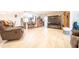 Spacious living room with tile flooring, a stone fireplace, and ample seating for entertaining at 10326 W Kingswood Cir, Sun City, AZ 85351
