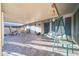 A covered patio with comfortable swing and furniture providing a relaxing outdoor living space at 10326 W Kingswood Cir, Sun City, AZ 85351