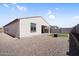 Wide shot of the home's backyard, highlighting the neutral desert landscaping at 11341 E Unger Ave, Mesa, AZ 85212