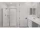 Modern bathroom showcasing a glass-enclosed shower, contemporary fixtures, and pristine white color palette at 11341 E Unger Ave, Mesa, AZ 85212