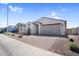 A charming single-story home featuring desert landscaping and brick-paved driveway at 11341 E Unger Ave, Mesa, AZ 85212