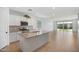Well-lit kitchen with a large island, modern appliances, and tile backsplash at 11341 E Unger Ave, Mesa, AZ 85212