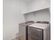 Well-lit laundry area with side-by-side washer and dryer units and a useful shelf above at 11341 E Unger Ave, Mesa, AZ 85212