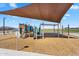 Community playground featuring modern play structure with sunshade and wood chip ground covering at 11341 E Unger Ave, Mesa, AZ 85212