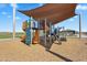 Modern community playground with varied play equipment and a large sunshade for outdoor fun at 11341 E Unger Ave, Mesa, AZ 85212