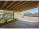 Covered back patio with a concrete floor overlooks the spacious backyard with a desert landscape at 1137 W 21St Ave, Apache Junction, AZ 85120