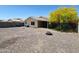 Spacious backyard featuring desert landscaping, a charming fire pit, and a covered patio at 1137 W 21St Ave, Apache Junction, AZ 85120