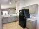 Bright kitchen features stainless dishwasher and refrigerator and neutral cabinets flowing into open living area at 1137 W 21St Ave, Apache Junction, AZ 85120