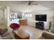 Open concept living room with tile flooring, ceiling fan, piano and comfortable seating at 1137 W 21St Ave, Apache Junction, AZ 85120