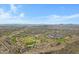 Panoramic aerial view showcasing a sprawling suburban golf community in a desert landscape at 11413 S Coolwater Dr, Goodyear, AZ 85338