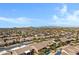 Scenic aerial view showcases the community, highlighting desert landscaping and mountain views, some homes with solar panels at 11413 S Coolwater Dr, Goodyear, AZ 85338
