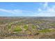 Expansive aerial view of a suburban desert golf community with lush green fairways at 11413 S Coolwater Dr, Goodyear, AZ 85338