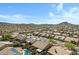Scenic aerial view showcasing the community, highlighting desert landscaping and mountain views with some homes with pools at 11413 S Coolwater Dr, Goodyear, AZ 85338