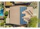 Aerial view of a home with solar panels, tile roof, and a backyard pool at 11413 S Coolwater Dr, Goodyear, AZ 85338
