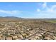 Aerial view of a desert community featuring tile roofs, desert landscaping and mountain views at 11413 S Coolwater Dr, Goodyear, AZ 85338