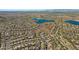 Gorgeous aerial view of a Primary-planned community with lake, offering beautiful desert landscaping and mountain views at 11413 S Coolwater Dr, Goodyear, AZ 85338