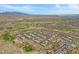 Wonderful aerial photo of a golf course community, highlighting desert landscaping and mountain views at 11413 S Coolwater Dr, Goodyear, AZ 85338