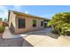 Property backyard showcasing covered patio, sidewalk, and exterior of the home at 11413 S Coolwater Dr, Goodyear, AZ 85338