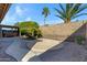 Backyard featuring a patio area with mature landscaping and privacy wall at 11413 S Coolwater Dr, Goodyear, AZ 85338