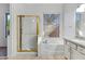 Bathroom showcasing a glass shower, soaking tub under a window, and granite vanity at 11413 S Coolwater Dr, Goodyear, AZ 85338