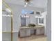 Bright bathroom featuring double sinks, tile flooring, and vaulted ceilings at 11413 S Coolwater Dr, Goodyear, AZ 85338