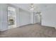 Spacious bedroom with neutral carpet, arched doorway, and an attached bathroom at 11413 S Coolwater Dr, Goodyear, AZ 85338
