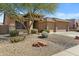 Beautiful single-story home with a three-car garage, a tile roof, and low-maintenance desert landscaping at 11413 S Coolwater Dr, Goodyear, AZ 85338
